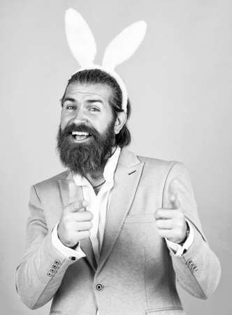 you are next. celebration concept. brutal handsome man with moustache. mature guy wear rabbit ears. happy easter. spring holiday and party. funny bearded hipster in bunny earsの写真素材