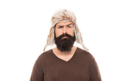 sad mature guy with beard in earflape hat isolated on white background, casual