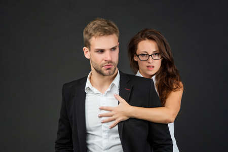 man and woman in glasses. business partners on black background. formal couple in love.