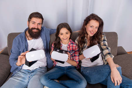 mom dad and daughter. digital future and innovation. modern life.の写真素材