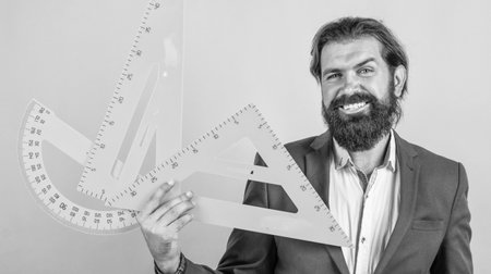 mature bearded man teacher in costume sit in school classroom with blackboard, measurementの写真素材