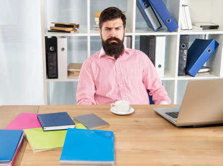 Serious office worker. Businessman sitting at desk. Office work