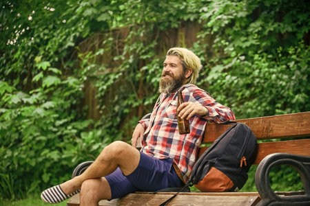 Inspire. Handsome man working on his laptop. business man working outdoors with computer. start video conferencing. communication by video call. businessman with laptop sitting on bench at parkの写真素材