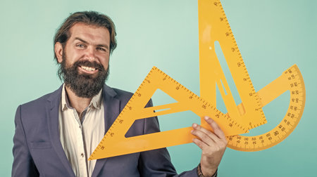 mature bearded man teacher in costume sit in school classroom with blackboard, measurementの写真素材