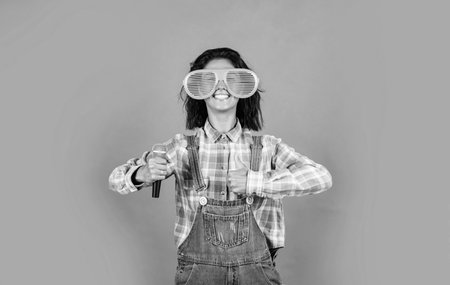 nice day. female singer use microphone. cheerful woman event manager. girl singing in karaoke. feel happiness and joy. happy beautiful lady in denim style hold mic. music and vocalの写真素材