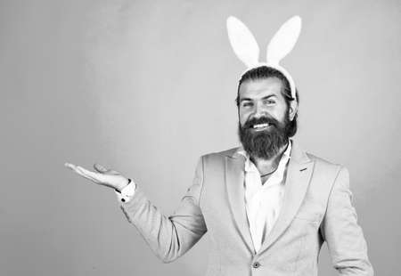 Man in bunny ears. rabbit man wear hare ears. bunny hunt begins. happy hipster with beard. Man in rabbit ears. Preparation for Easter. concept of egg hunt. Easter celebration concept. Spring holidaysの写真素材
