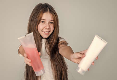 teen child cleaning hair with shampoo. kid presenting shower gel. body care cosmetic bath shower. skin lotion or scrub. strong and resilient. cheerful girl condition hair. Enjoying his perfecの写真素材