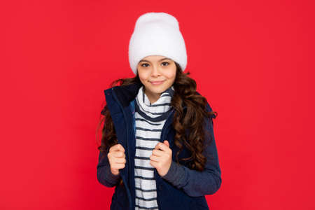 portrait of child wearing warm clothes. express positive emotion. winter fashion.