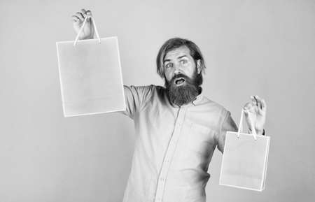 I take two. holiday celebration. surprise for him. shopping and sale. mature brutal hipster with present. buy in mall. happy bearded man holding gift package. happy birthday or anniversaryの写真素材