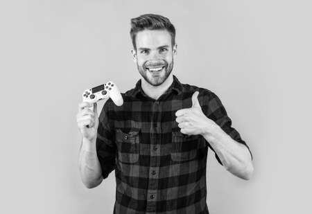 male with fashionable groomed hair and beard play computer game with console, winnerの写真素材