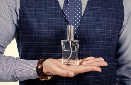 cologne for men. Perfumer shop assistant guy presenting product. Man perfume and fragranceの写真素材