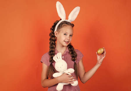 bunny girl hold easter rabbit toy ready for egg hunt, easter eggsの写真素材