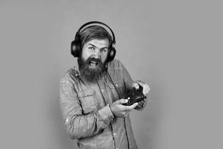Lets Play Better. concept of online gaming. audio game guide. play computer game. new technology in modern life. digital living. hipster with console. bearded man wearing headphones. the gameの写真素材
