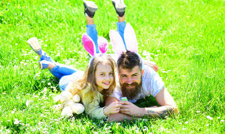 Teamwork concept. Dad and girl found easter eggs in traditional hunting game in. Man with beard and...