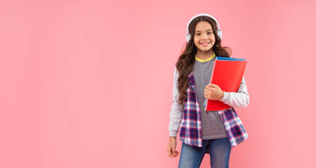 happy child in modern earphones hold workbook. online education. back to school.