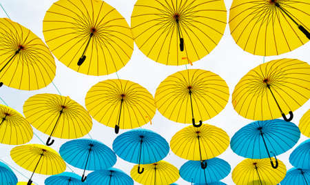 Multicolored umbrella sky background. Hanging street decoration bottom-upの写真素材