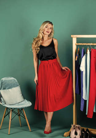 elegant woman choosing clothes in fashion boutique, wardrobe