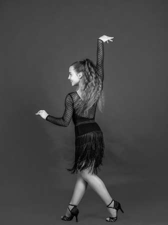 kid dancing in black dress. child in dance pose. professional slowfox and quickstep. waltz and...