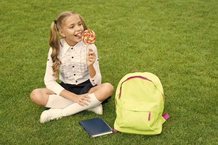 Candy kid. Happy schoolchild enjoy lollipop. Sweet tooth. Candy eating. Lollipop fun