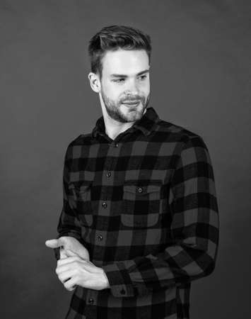 young handsome guy in red checkered shirt. stylish male wear casual clothes. bearded man with bristle on unshaven face. fashion and beauty. barbershop concept. mens wearの写真素材