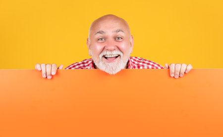 smiling senior man with copy space on blank banner