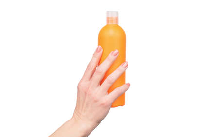 female hands hold lotion bottle with copy spaceの写真素材