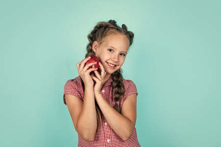 happy girl holding apples from garden. kid hold fresh fruit. child eating red apple. summer healthy food. vegetarian dieting. fruits at fall harvest. Healthy nutrition in autumn. Spring collectionの写真素材