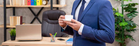 cropped entrepreneur in jacket having coffee break at office, businesspersonの写真素材