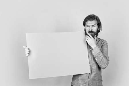 perfect service. brutal caucasian hipster with moustache. male barber facial care. confident and handsome. announcement and advertisement. thoughtful mature man. guy with beard hold bannerの写真素材