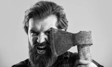 brutal man lumberjack with axe cut hair, barber