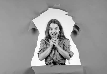 sing with me. happy teen girl singing song in microphone. happy childhood.の写真素材