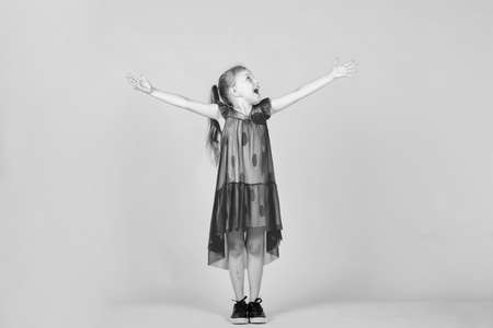 happy teen girl in pink dress on yellow background, happinessの写真素材