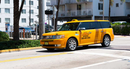 Miami Beach, Florida USA - April 14, 2021: ford sunshine taxi car, corner view. yellow ambassador cabのeditorial素材