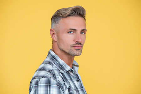 mature man with hoary hair on yellow background