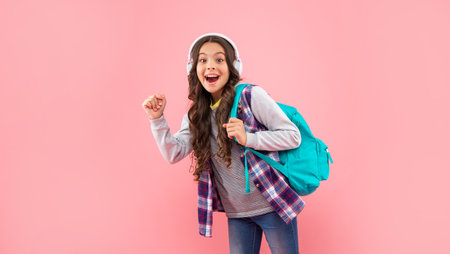 amazed child in modern earphones with backpack. online education. back to school.
