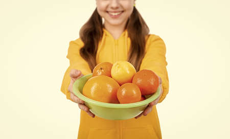 fruit full of vitamins in hands of cropped teen girl isolated on white selective focus, organic.の写真素材