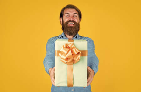 Shocked and happy. bearded man ready for holiday. sale and discount. mature hipster with beard hold present box. brutal caucasian hipster with gift. male go shopping. successful shopaholic in shirtの写真素材