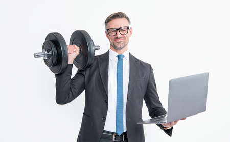 successful businessman in suit hold heavy dumbbell and laptop isolated on white backgroundの写真素材