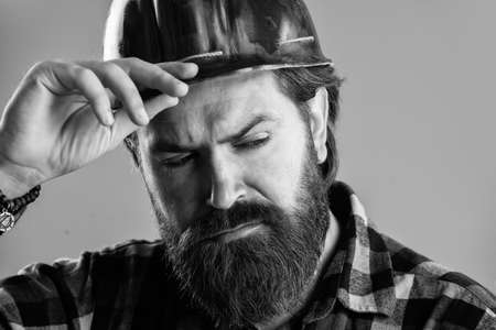 brutal man builder in uniform and helmet, buildingの写真素材