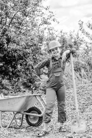 happy kid use construction wheelbarrow.の写真素材