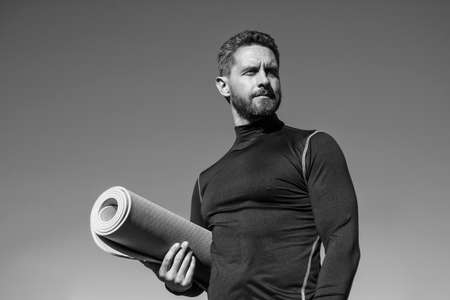 athletic muscular man hold yoga mat, pilatesの写真素材