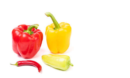 Variety of red and yellow colored bell and chili peppers isolated on white, copy spaceの写真素材