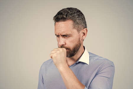 Middle-aged man manager coughing of respiratory infection blue background, coughの写真素材
