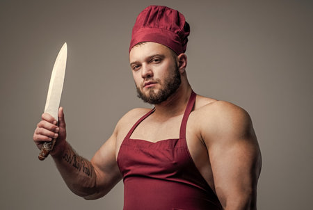 muscular man butcher in chef apron hold knife kitchen utensil, cuisineの写真素材