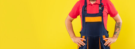 cropped man mechanic in work clothes on yellow background with copy space