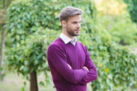 young handsome man in casual style crossed hands outdoorの写真素材