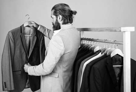 atelier or wardrobe. true gentleman with groomed hair. male beauty and fashion. showroom concept. bearded man in formalwear. elegant businessman choose elegant apparel for formal event. Cool and sexyの写真素材