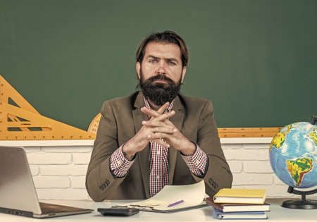 very hard day. brutal man with beard wear costume. informal education. male student sit in classroom while lesson. pass the exam. learning the subject. back to school. happy teachers dayの写真素材