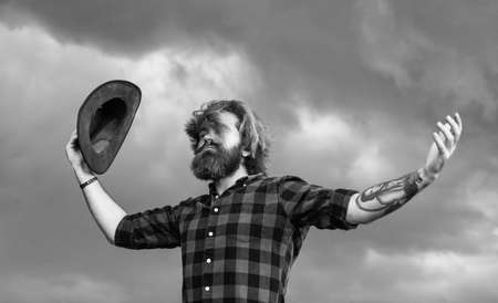 brutal bearded male man hold cowboy hat, freedomの写真素材