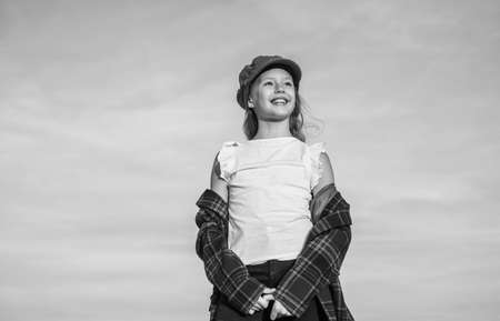 teen girl wear trendy hat and checkered jacket looking far away on sky, freedomの写真素材